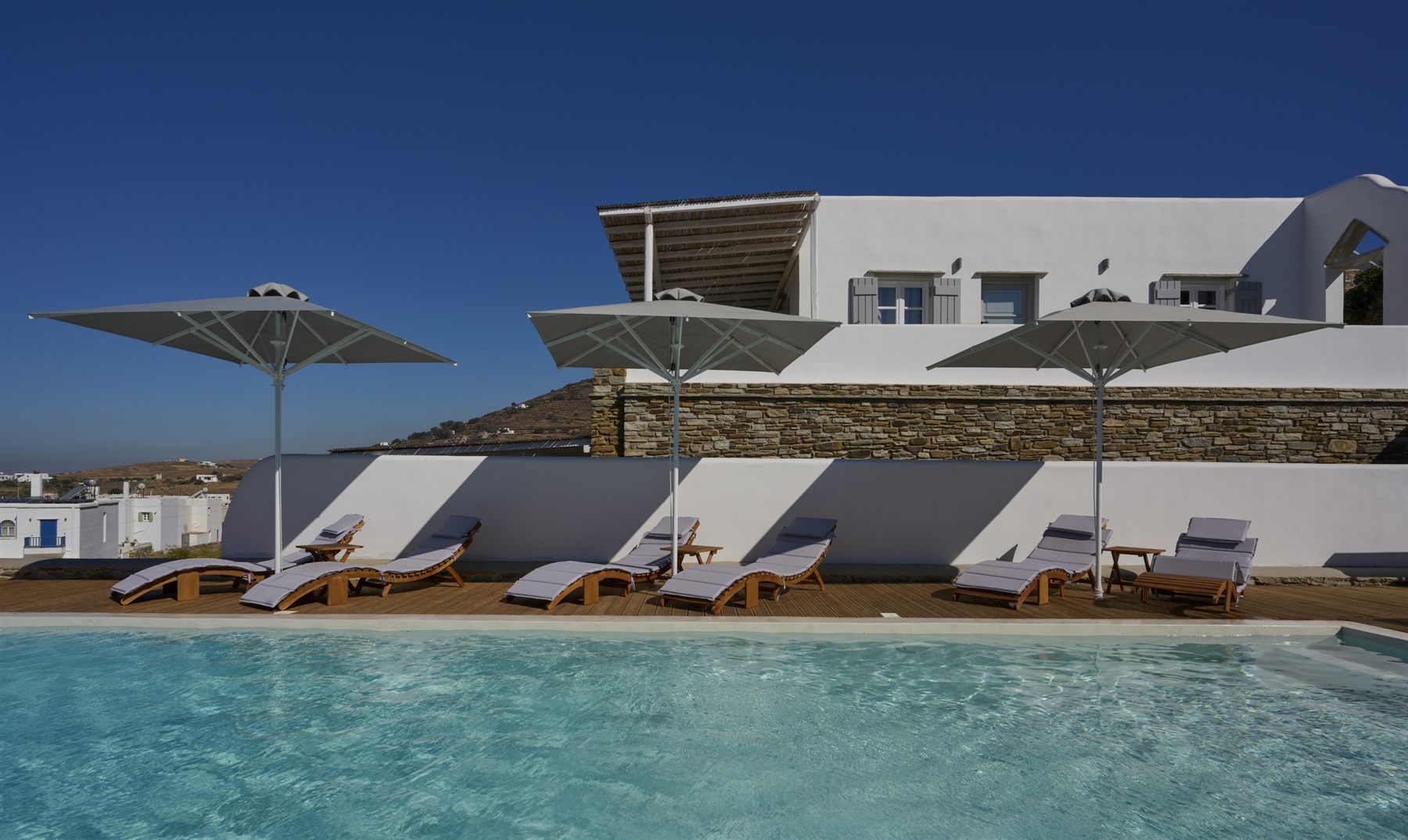 Loungers and parasols along one side of the pool